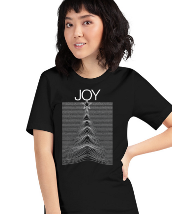 Woman wearing a black JOY women’s t-shirt featuring a star and waveform graphic design, perfect for music and holiday style.